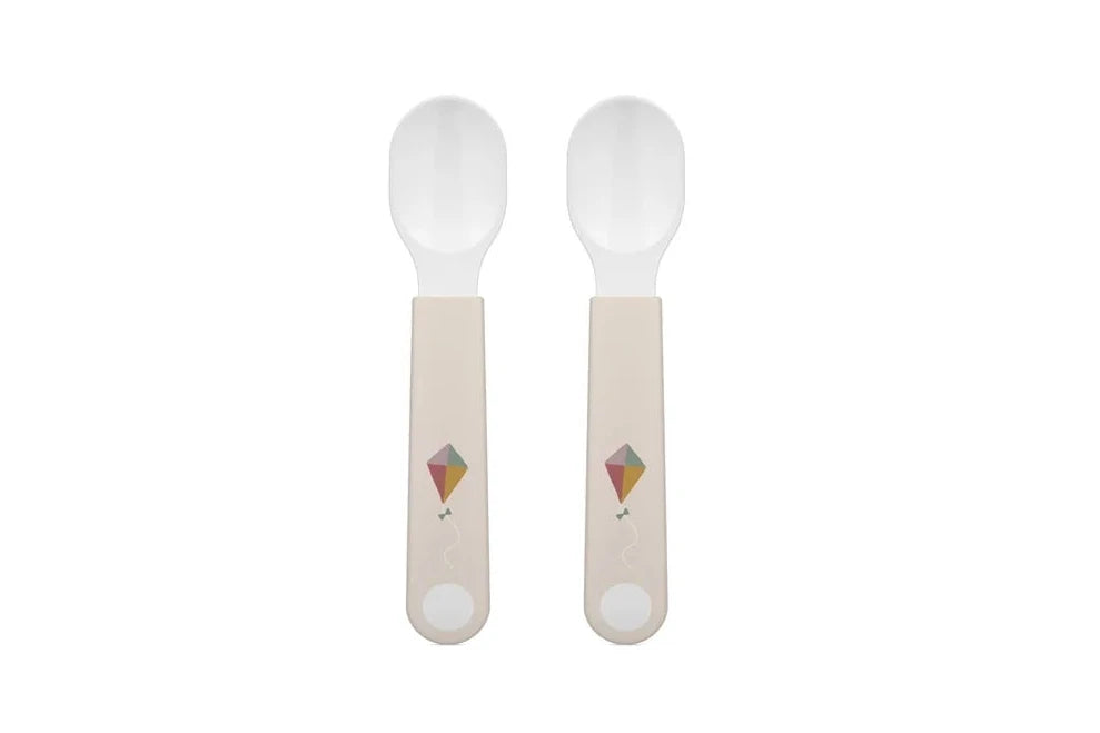Two spoons with light-colored handles on a white background
